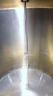 Used Tank, 2000 Gallon, 304 Stainless Steel Vertical. 84” Diameter x 80” straight side. Dished top, coned bottom. Off center top entering Lightnin air operated agitator, model XJAC-100. 1-1/2” Diamet...