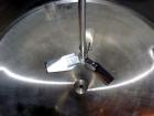 Used Tank, 1,200 Gallon, Stainless Steel, Vertical. Open top with lids, dished bottom. Side mounted level gauge and bridge mounted 1 hp agitator.  1-1/2’’ Center bottom outlet.  Mounted on (4) stainl...