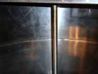 Used Tank, 1,200 Gallon, Stainless Steel, Vertical. Open top with lids, dished bottom. Side mounted level gauge and bridge mounted 1 hp agitator.  1-1/2’’ Center bottom outlet.  Mounted on (4) stainl...