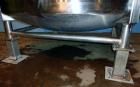 Used Tank, 1,200 Gallon, Stainless Steel, Vertical. Open top with lids, dished bottom. Side mounted level gauge and bridge mounted 1 hp agitator.  1-1/2’’ Center bottom outlet.  Mounted on (4) stainl...