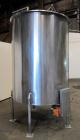Used Tank, 1000 Gallon, 304 Stainless Steel, Vertical. Approximate 61” diameter x 81” straight side, flat top with a bolt on cover with a 1/3 hinged opening, sloped bottom. Side bottom entering agita...