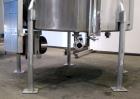 Used Tank, 1000 Gallon, 304 Stainless Steel, Vertical. Approximate 61” diameter x 81” straight side, flat top with a bolt on cover with a 1/3 hinged opening, sloped bottom. Side bottom entering agita...