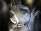 Used Tank, 1000 Gallon, 304 Stainless Steel, Vertical. Approximate 61” diameter x 81” straight side, flat top with a bolt on cover with a 1/3 hinged opening, sloped bottom. Side bottom entering agita...