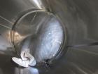 Used Tank, 2225 Gallon, 304 Stainless Steel, Vertical. Approximate 79” diameter x 105” straight side, flat welded top, sloped bottom. Side bottom entering agitator, 3 blade prop driven by a 5hp, 3/60...