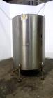 Used Tank, 1050 Gallons, 304 Stainless Steel, Vertical.  Approximately 62” diameter x 82” straight side.  Flat top, sloped bottom.  Off-center top entering Lightnin agitator, model N33G-150.  1-1/2” ...