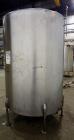 Used Tank, 1050 Gallons, 304 Stainless Steel, Vertical.  Approximately 62” diameter x 82” straight side.  Flat top, sloped bottom.  Off-center top entering Lightnin agitator, model N33G-150.  1-1/2” ...