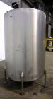 Used Tank, 1050 Gallons, 304 Stainless Steel, Vertical.  Approximately 62” diameter x 82” straight side.  Flat top, sloped bottom.  Off-center top entering Lightnin agitator, model N33G-150.  1-1/2” ...