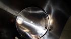 Used Tank, 1050 Gallons, 304 Stainless Steel, Vertical.  Approximately 62” diameter x 82” straight side.  Flat top, sloped bottom.  Off-center top entering Lightnin agitator, model N33G-150.  1-1/2” ...