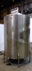 Used Tank, 1050 Gallon, 304 Stainless Steel, Vertical.  Approximately 62” diameter x 82” straight side.  Dished top, sloped bottom.  Off-center top entering Lightnin agitator, model N33G-150.  1-1/2”...