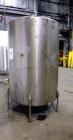 Used Tank, 1050 Gallon, 304 Stainless Steel, Vertical.  Approximately 62” diameter x 82” straight side.  Dished top, sloped bottom.  Off-center top entering Lightnin agitator, model N33G-150.  1-1/2”...