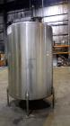 Used Tank, 1050 Gallon, 304 Stainless Steel, Vertical.  Approximately 62” diameter x 82” straight side.  Dished top, sloped bottom.  Off-center top entering Lightnin agitator, model N33G-150.  1-1/2”...