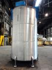 Used Tank, 3400 Gallon, 304 Stainless Steel, Vertical. Approximate 84” diameter x 143” straight side, flat top with 1/3 hinged cover, sloped bottom. Fixed carbon steel agitator bridge with a top ente...