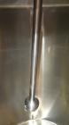 Used Tank, 1000 Gallon, 304 Stainless Steel, Vertical. 60” Diameter x 82” straight side, flat welded top, sloped bottom. Side Bottom entering agitator with a 3 blade prop, driven by a 3hp, 3/60/230/4...