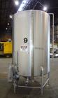 Used Tank, 1000 Gallon, 304 Stainless Steel, Vertical. 60” Diameter x 82” straight side, flat welded top, sloped bottom. Side Bottom entering agitator with a 3 blade prop, driven by a 2hp, 3/60/208-2...