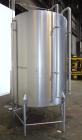 Used Tank, 1000 Gallon, 304 Stainless Steel, Vertical. 60” Diameter x 82” straight side, flat welded top, sloped bottom. Side Bottom entering agitator with a 3 blade prop, driven by a 2hp, 3/60/208-2...