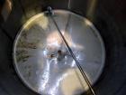 Used San-I-Tank, 2000 Gallon, 304 Stainless Steel, Vertical. 84” Diameter x 84” straight side, flat welded top, coned bottom. Lightnin clamp on agitator, model D-3. Approximate 1” diameter shaft with...