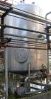 USED: Walker 3,500 gallon, type 304L stainless steel, storage tank. Vertical, dished heads. Approximate 8' diameter x 10' straight side. Misc top and side flanged openings. Side openings include an 1...