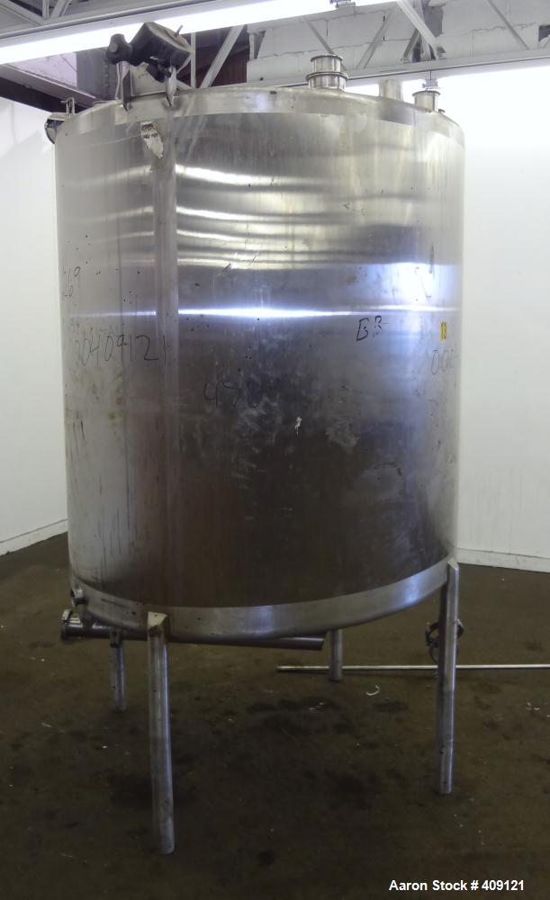 Used Tank, 575 Gallons, 304 Stainless Steel, Vertical, Approximately 55" Diameter X 58" Straight Side. Flat Top and Sloped Bottom. Top opening Lightnin Agitator model V5P18, serial number 93B65575, a...