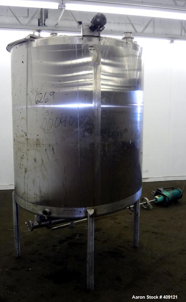 Used Tank, 575 Gallons, 304 Stainless Steel, Vertical, Approximately 55" Diameter X 58" Straight Side. Flat Top and Sloped Bottom. Top opening Lightnin Agitator model V5P18, serial number 93B65575, a...