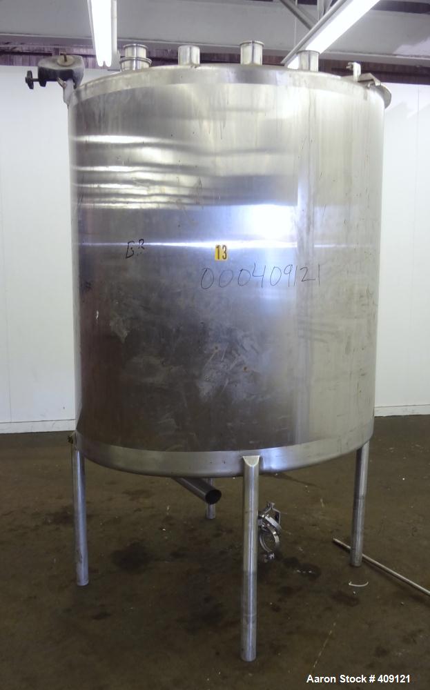 Used Tank, 575 Gallons, 304 Stainless Steel, Vertical, Approximately 55" Diameter X 58" Straight Side. Flat Top and Sloped Bottom. Top opening Lightnin Agitator model V5P18, serial number 93B65575, a...