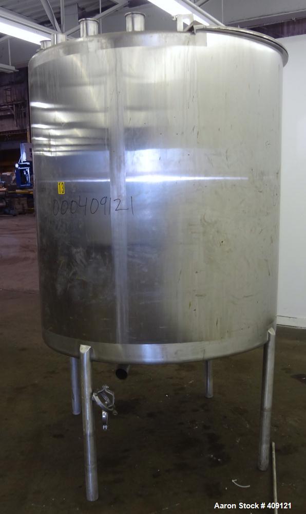 Used Tank, 575 Gallons, 304 Stainless Steel, Vertical, Approximately 55" Diameter X 58" Straight Side. Flat Top and Sloped Bottom. Top opening Lightnin Agitator model V5P18, serial number 93B65575, a...