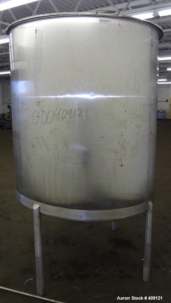 Used Tank, 575 Gallons, 304 Stainless Steel, Vertical, Approximately 55" Diameter X 58" Straight Side. Flat Top and Sloped Bottom. Top opening Lightnin Agitator model V5P18, serial number 93B65575, a...