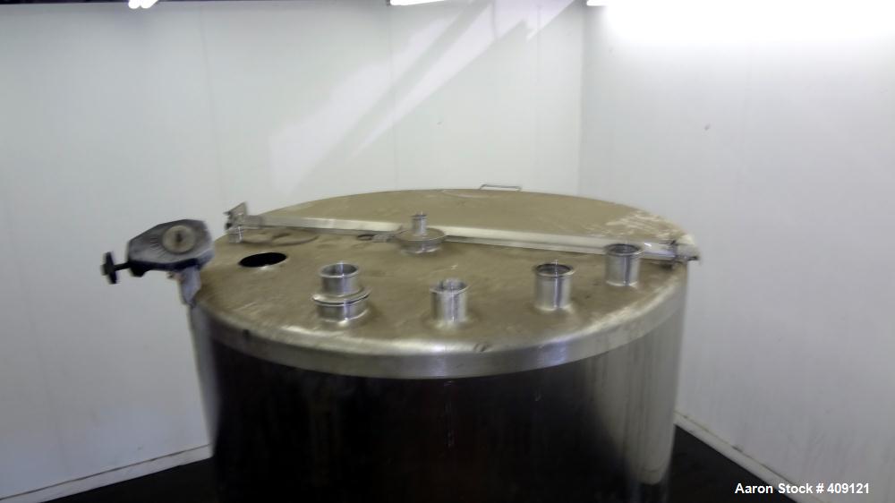 Used Tank, 575 Gallons, 304 Stainless Steel, Vertical, Approximately 55" Diameter X 58" Straight Side. Flat Top and Sloped Bottom. Top opening Lightnin Agitator model V5P18, serial number 93B65575, a...