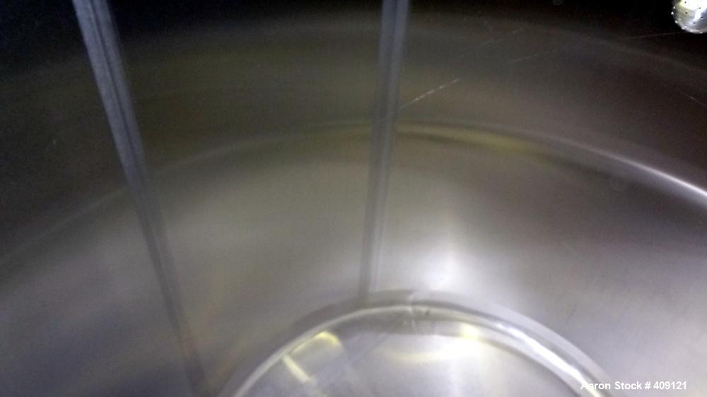 Used Tank, 575 Gallons, 304 Stainless Steel, Vertical, Approximately 55" Diameter X 58" Straight Side. Flat Top and Sloped Bottom. Top opening Lightnin Agitator model V5P18, serial number 93B65575, a...