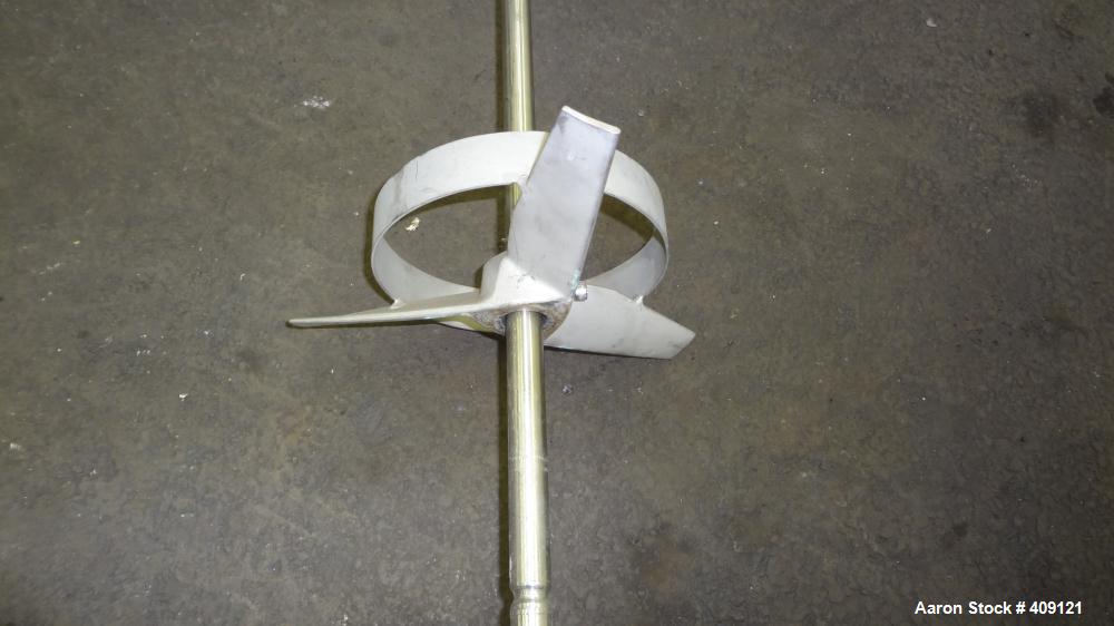 Used Tank, 575 Gallons, 304 Stainless Steel, Vertical, Approximately 55" Diameter X 58" Straight Side. Flat Top and Sloped Bottom. Top opening Lightnin Agitator model V5P18, serial number 93B65575, a...