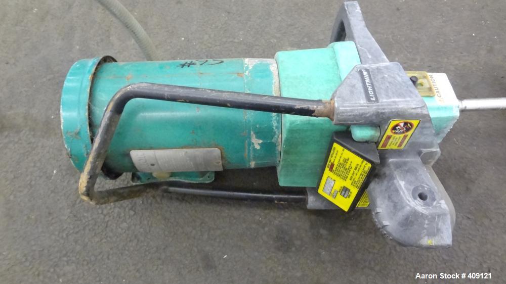 Used Tank, 575 Gallons, 304 Stainless Steel, Vertical, Approximately 55" Diameter X 58" Straight Side. Flat Top and Sloped Bottom. Top opening Lightnin Agitator model V5P18, serial number 93B65575, a...