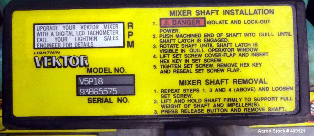 Used Tank, 575 Gallons, 304 Stainless Steel, Vertical, Approximately 55" Diameter X 58" Straight Side. Flat Top and Sloped Bottom. Top opening Lightnin Agitator model V5P18, serial number 93B65575, a...