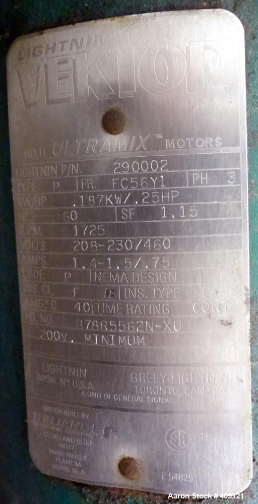 Used Tank, 575 Gallons, 304 Stainless Steel, Vertical, Approximately 55" Diameter X 58" Straight Side. Flat Top and Sloped Bottom. Top opening Lightnin Agitator model V5P18, serial number 93B65575, a...