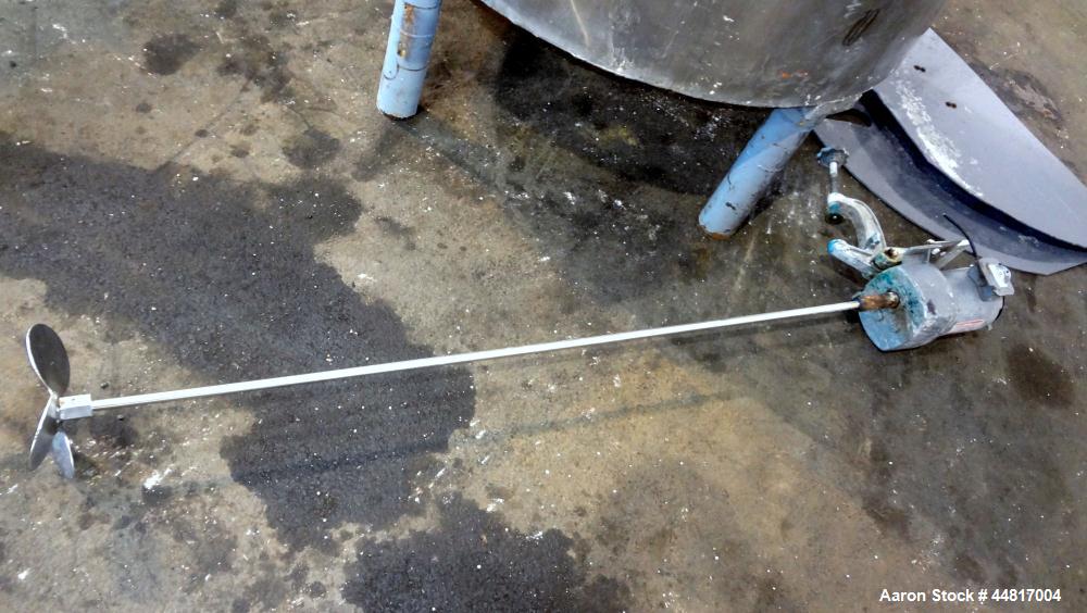 Used Tank, 550 Gallons, 304 Stainless Steel, Vertical. Approximately 48" diameter x 72" straight side. Flat open top with a plastic cover, coned bottom. Top entering clamp on agitator, 3/4" diameter ...
