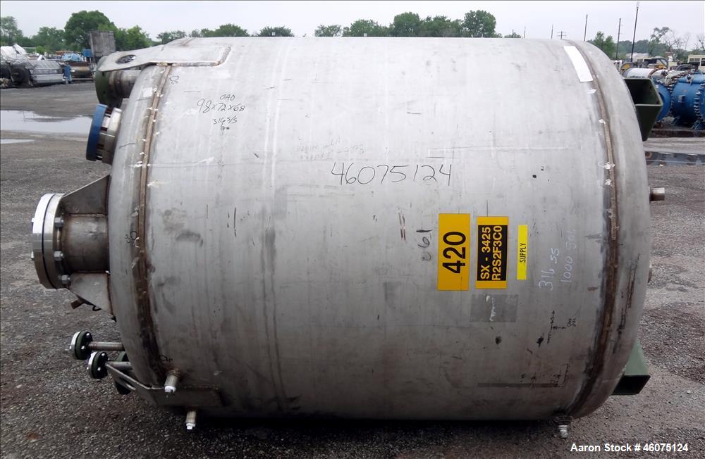 Used Tank, 975 Gallon, 316 Stainless Steel, Vertical. Approximate 66" diameter x 60" straight side, dished top/bottom. Top openings: (2) 3", (2) 1", (3) 4", 6", 6" sight glass, 8", 20" manway with co...