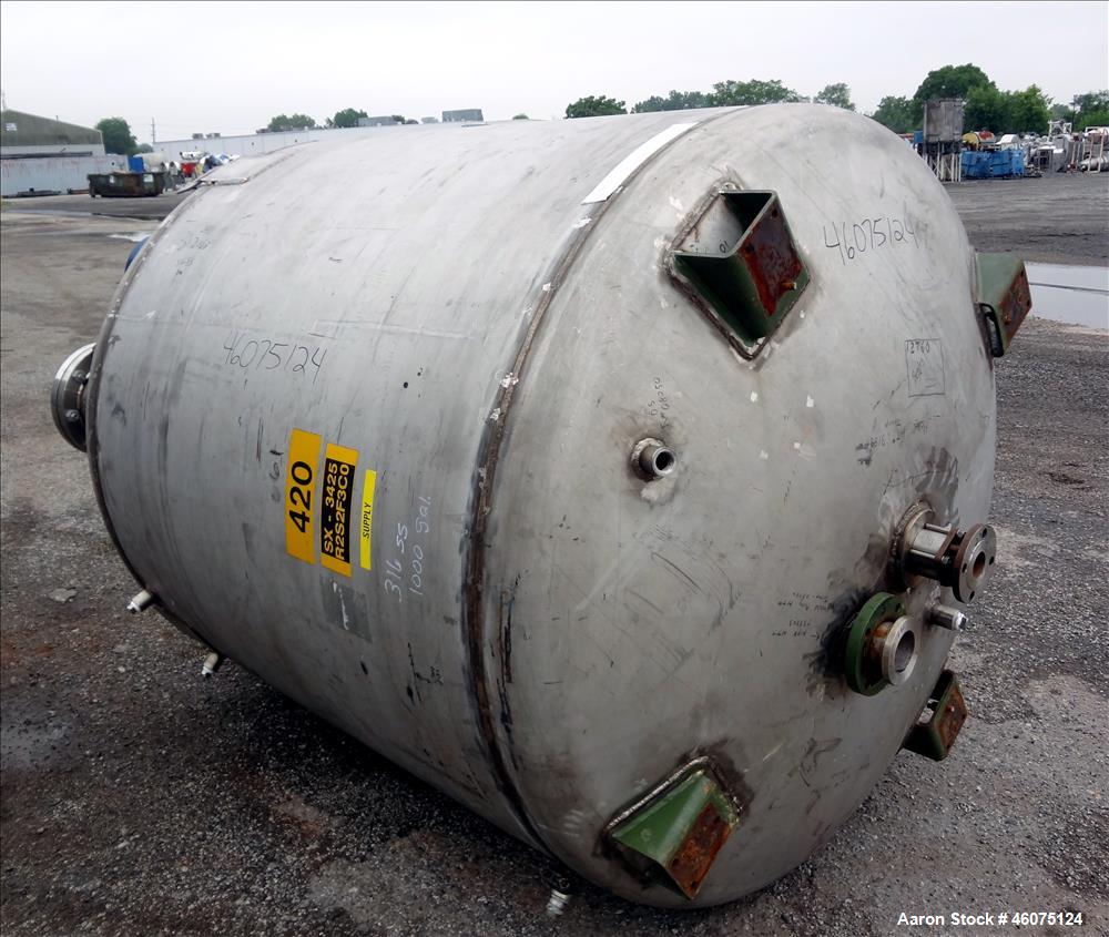 Used Tank, 975 Gallon, 316 Stainless Steel, Vertical. Approximate 66" diameter x 60" straight side, dished top/bottom. Top openings: (2) 3", (2) 1", (3) 4", 6", 6" sight glass, 8", 20" manway with co...
