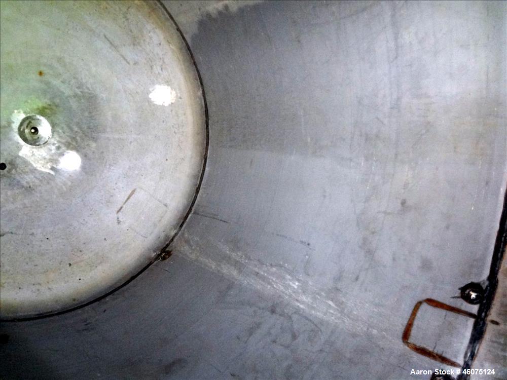 Used Tank, 975 Gallon, 316 Stainless Steel, Vertical. Approximate 66" diameter x 60" straight side, dished top/bottom. Top openings: (2) 3", (2) 1", (3) 4", 6", 6" sight glass, 8", 20" manway with co...