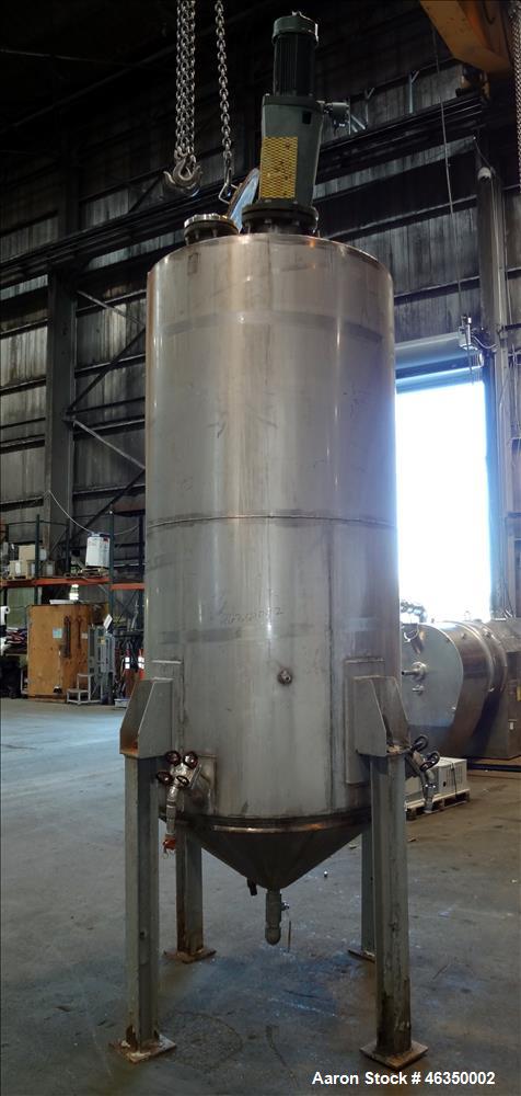 Used Tank, Approximately 750 Gallons, 304 Stainless Steel, Vertical. Approximately 48" diameter x 96" straight side. Dish top, jacketed 20" cone bottom, no rating. Top mounted off center Lightnin agi...