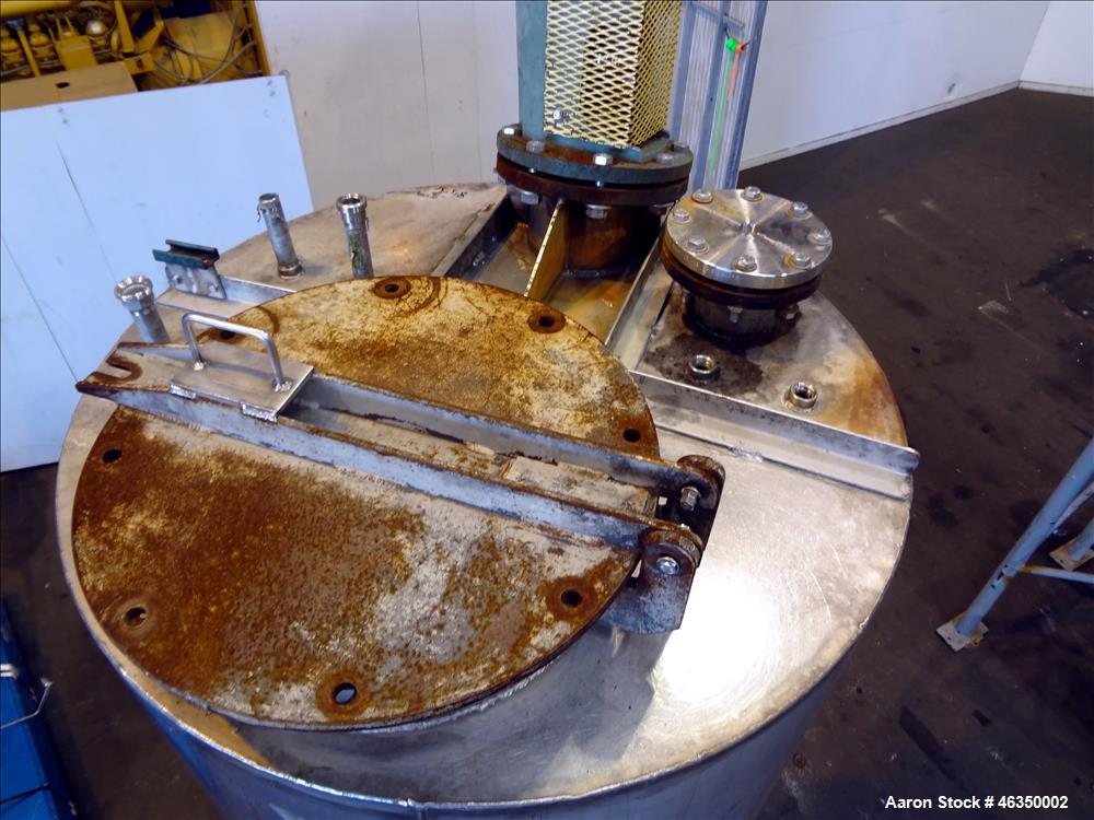Used Tank, Approximately 750 Gallons, 304 Stainless Steel, Vertical. Approximately 48" diameter x 96" straight side. Dish top, jacketed 20" cone bottom, no rating. Top mounted off center Lightnin agi...