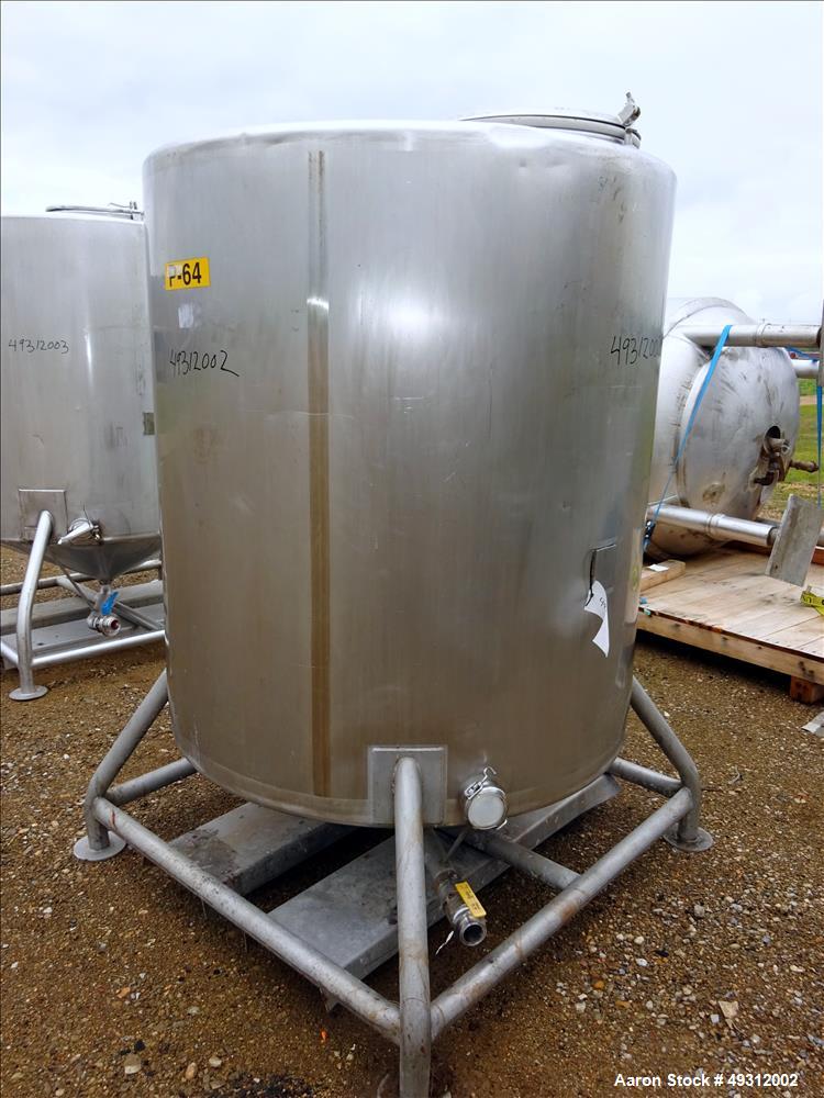 Used Tank, 500 Gallon, Stainless Steel, Vertical. Approximate 52" diameter x 54" straight side, flet top, coned bottom. Openings top 20" manway with cover, 4", side bottom 3", approximate 2" tangenti...