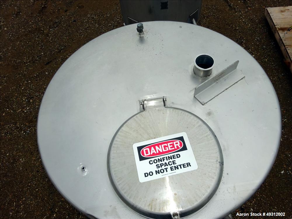 Used Tank, 500 Gallon, Stainless Steel, Vertical. Approximate 52" diameter x 54" straight side, flet top, coned bottom. Openings top 20" manway with cover, 4", side bottom 3", approximate 2" tangenti...