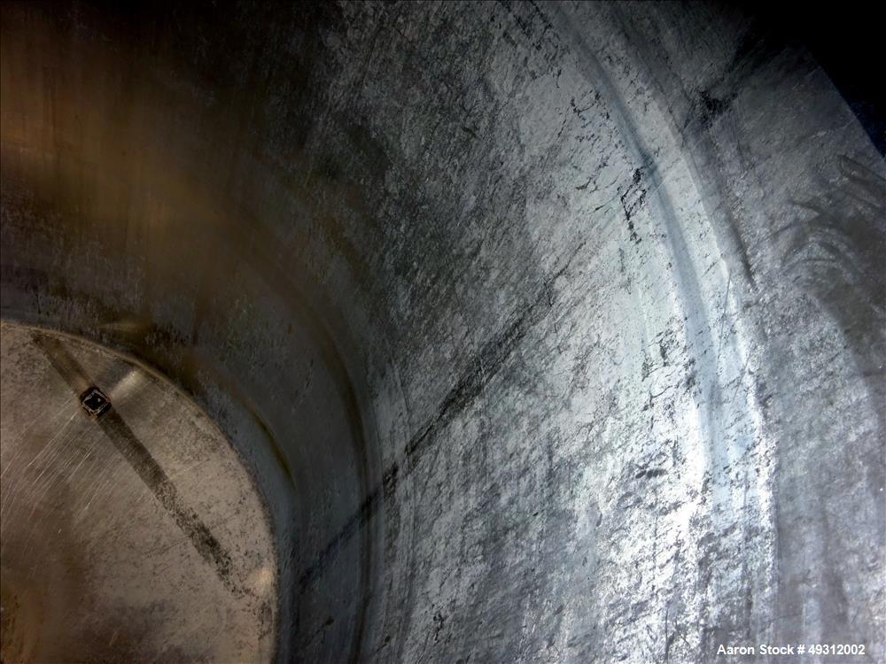 Used Tank, 500 Gallon, Stainless Steel, Vertical. Approximate 52" diameter x 54" straight side, flet top, coned bottom. Openings top 20" manway with cover, 4", side bottom 3", approximate 2" tangenti...