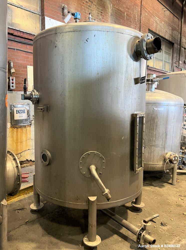 Used Tank, Approximate 950 Gallon, Stainless Steel, Vertical. Approximate 60" diameter x 72" straight side, dished top & bottom. Mounted on 4 stainless legs.