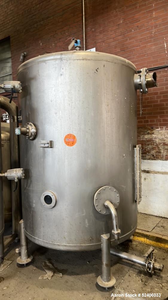 Used Tank, Approximate 950 Gallon, Stainless Steel, Vertical. Approximate 60" diameter x 72" straight side, dished top & bottom. Mounted on 4 stainless legs.