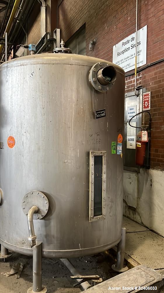 Used Tank, Approximate 950 Gallon, Stainless Steel, Vertical. Approximate 60" diameter x 72" straight side, dished top & bottom. Mounted on 4 stainless legs.