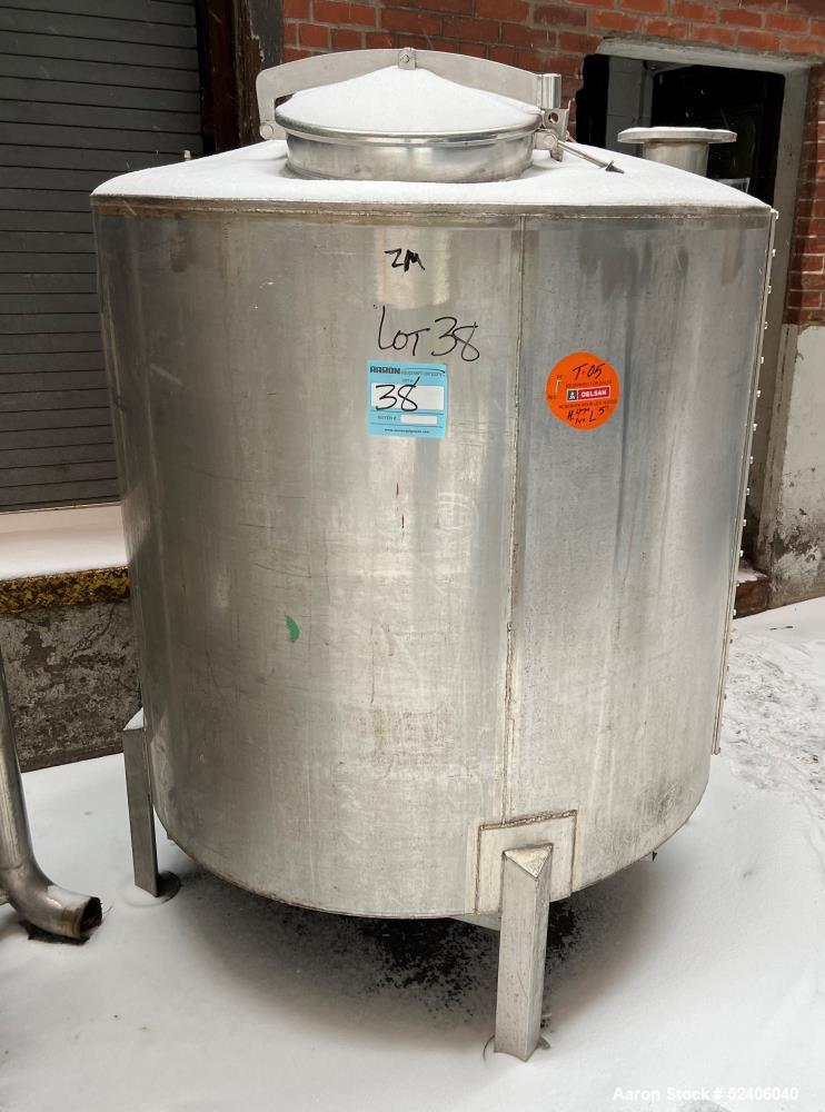 Used Tank, Approximate 650 Gallon, Stainless Steel, Vertical. Approximate 60" diameter x 54" straight side, coned top, sloped bottom. Mounted on 4 stainless legs.