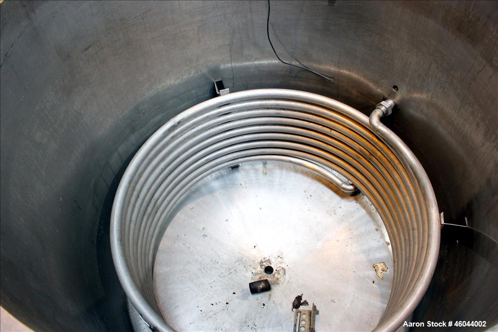 Used Filpaco Product Tank, 800 Gallon, 304 Stainless Steel, Vertical. 64" Diameter x 60" straight side. Flat top with no cover, coned bottom. 2" Internal pipe heating coil, approximately 24" tall. 2"...