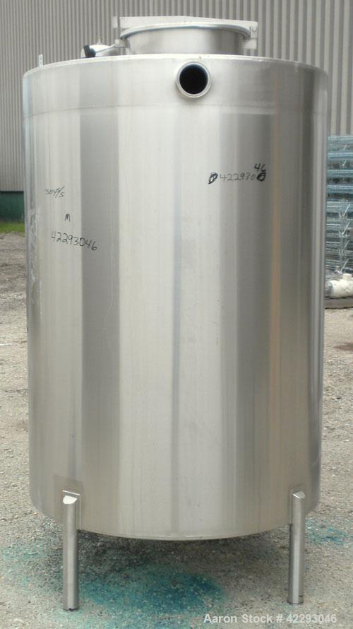 Used Hartel Tank, 500 Gallon, 304 Stainless Steel, Vertical. 48" Diameter x 66" straight side. Flat top and bottom. Openings: top 1-1/2" tri-clamp, 2" tri-clamp, (3) 3" tri-clamp, 16" manway with cov...
