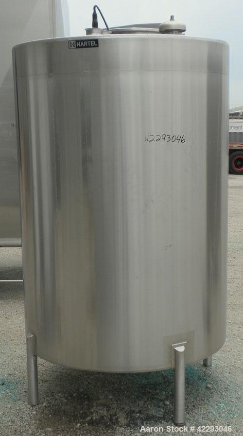Used Hartel Tank, 500 Gallon, 304 Stainless Steel, Vertical. 48" Diameter x 66" straight side. Flat top and bottom. Openings: top 1-1/2" tri-clamp, 2" tri-clamp, (3) 3" tri-clamp, 16" manway with cov...