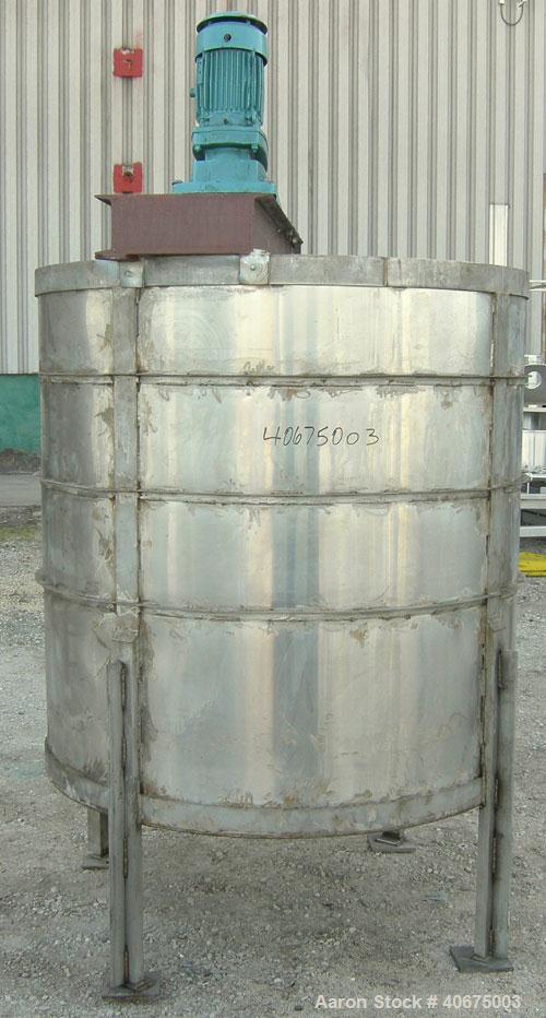 Used Tank, 700 gallon, 304 stainless steel, vertical. 58" diameter x 60" straight side. Open top, no cover, coned bottom. Off center bolt on carbon steel agitator bridge with a Chemineer agitator, mo...