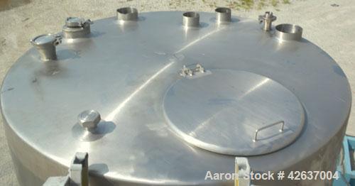 Used Tank, 825 Gallon, 304 Stainless Steel, Vertical. Approximately 55-1/2" diameter x 80" straight side, flat top, sloped bottom. Openings top 1-1/2" tri-clamp, (2) 3" tri-clamp, (2) 3", (2) 4-1/2",...